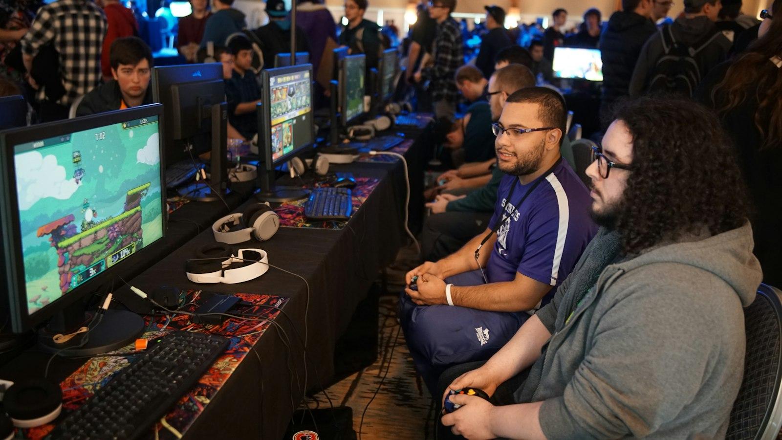 Players competing side by side at gaming stations during a tournament